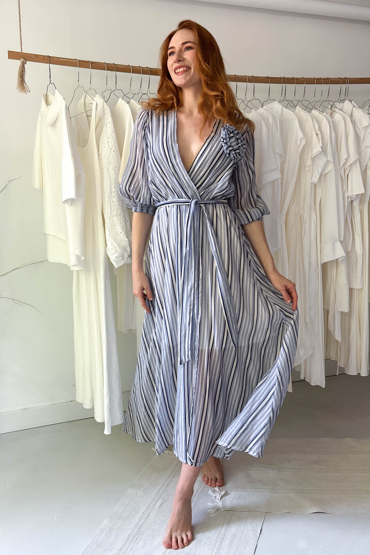 Blue striped light dress with flower brooch