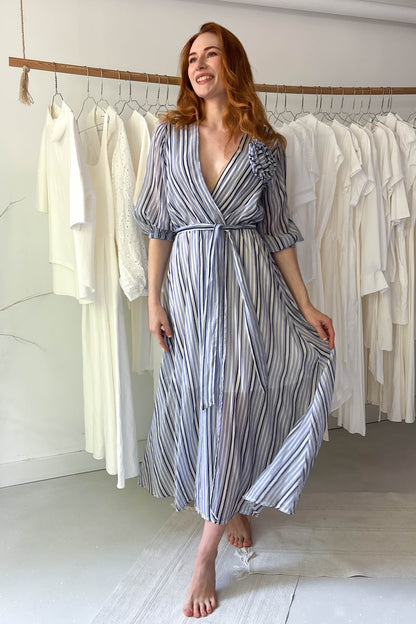 Blue striped light dress with flower brooch
