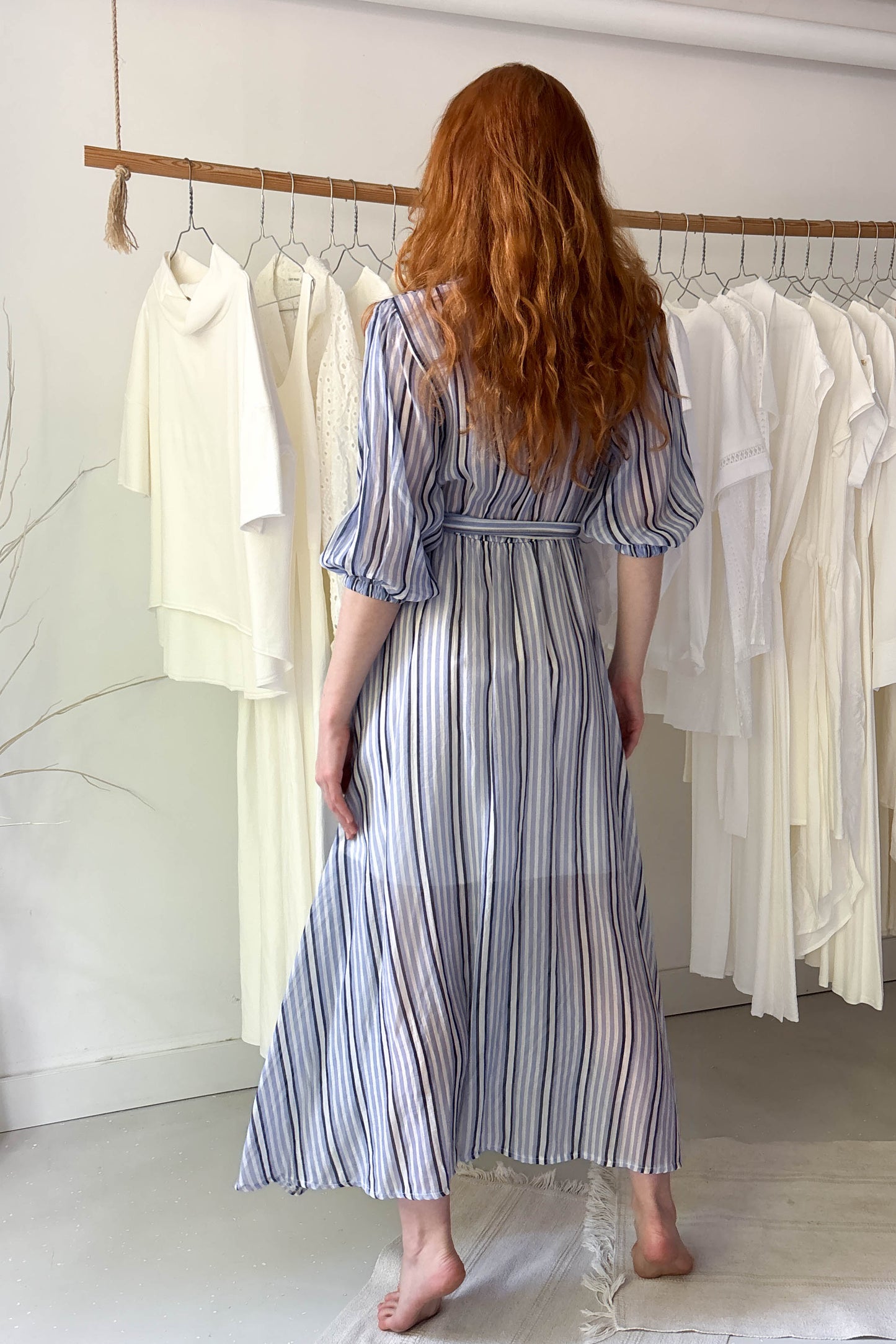 Blue striped light dress with flower brooch