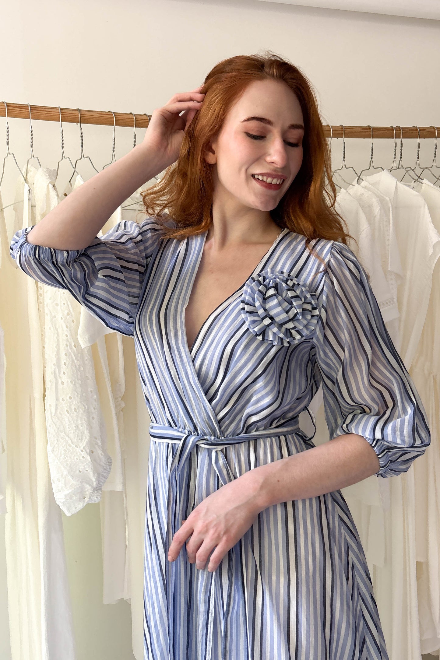 Blue striped light dress with flower brooch